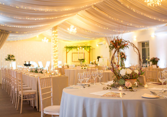 Marquee with fairy lights and tables for wedding meal at Aberdeen Wedding Venue Logie Country House